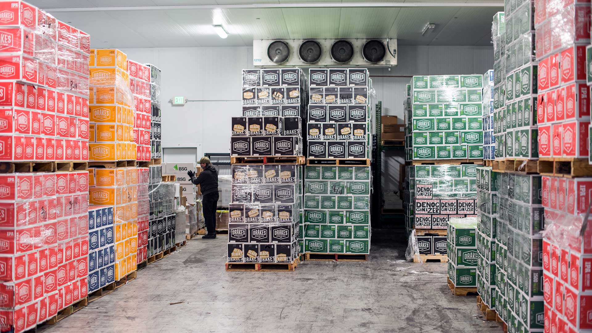 Interior view of Cold Box filled with pallets and cases of Drake's beer