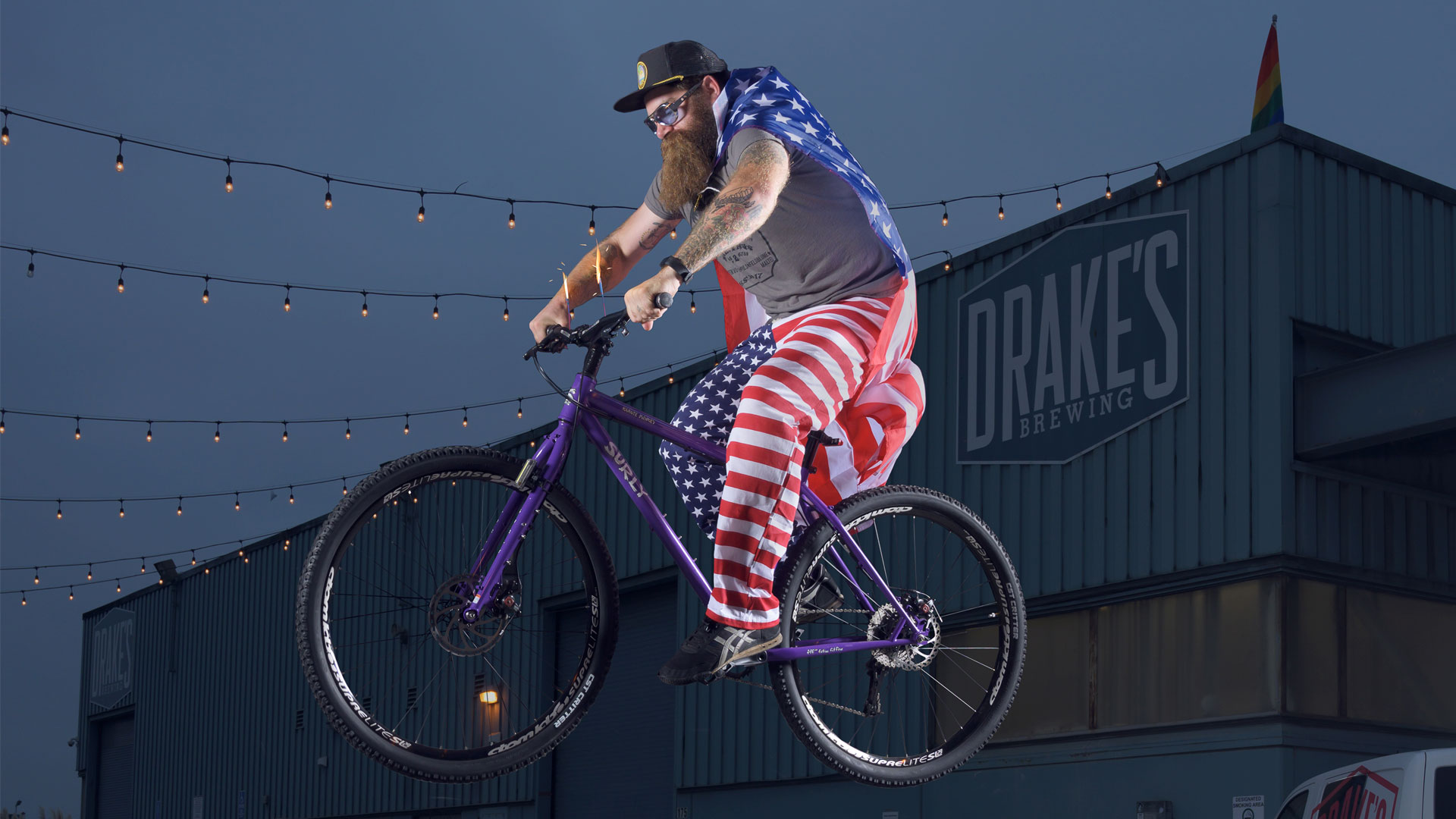 Drake's brewer riding bike in USA colors