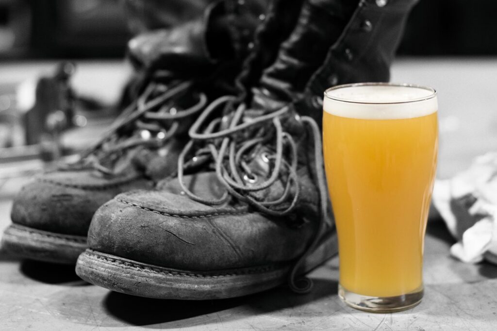 work boots with a glass of hazy IPA