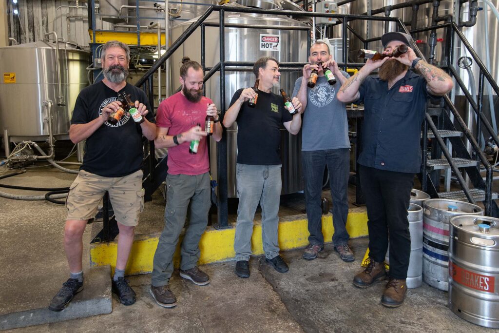 Drake's staff with the owners of Dos Aves Cerveceria
