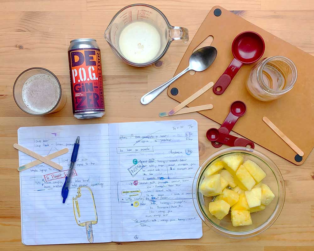Open recipe notebook and ingredients for the perfect beer popsicles