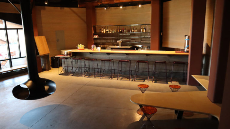 Private bar setting showing bartop, fireplace, and tables