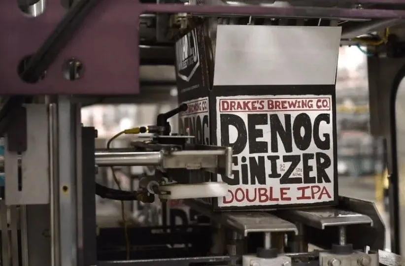 Drake's Brewing Co. Denogginizer Double IPA cans on a packaging line