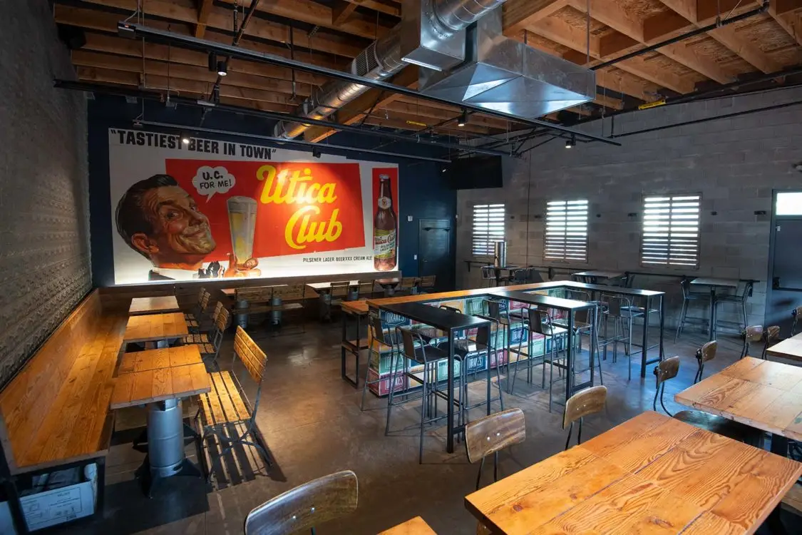 Interior of a brewery with a vintage Utica Club beer advertisement mural